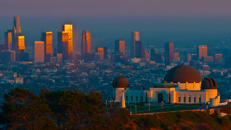 a city skyline with a large observatory in the foreground