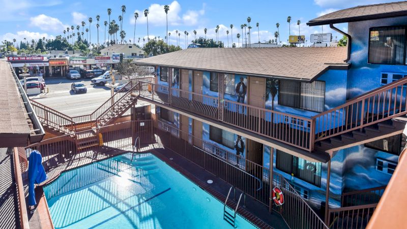 A two-story building with a pool and parking lot